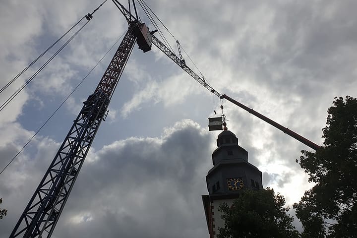 Kranhub über einer Kirchturmspitze